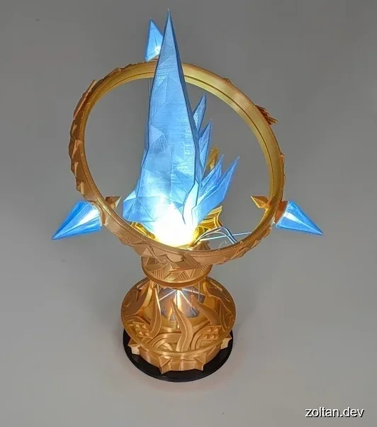 A 3D printed Aetheryte Crystal statue, printed in gold PLA with glowing transparent blue crystals