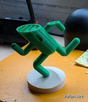 A half-printed Cactuar showing grid infill.