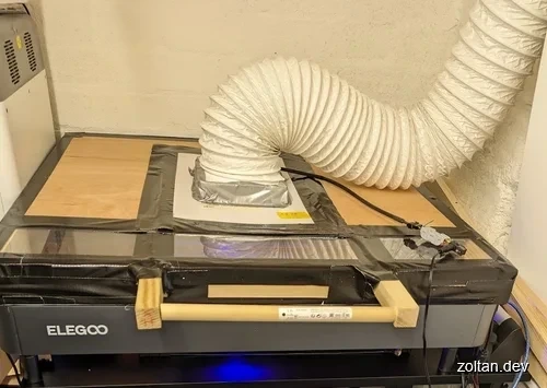 An Elegoo laser cutter with a wooden enclosure.
