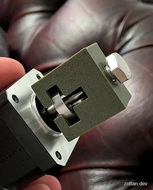 Close-up view of a gear puller, pulling an aluminium hub from a steel shaft.