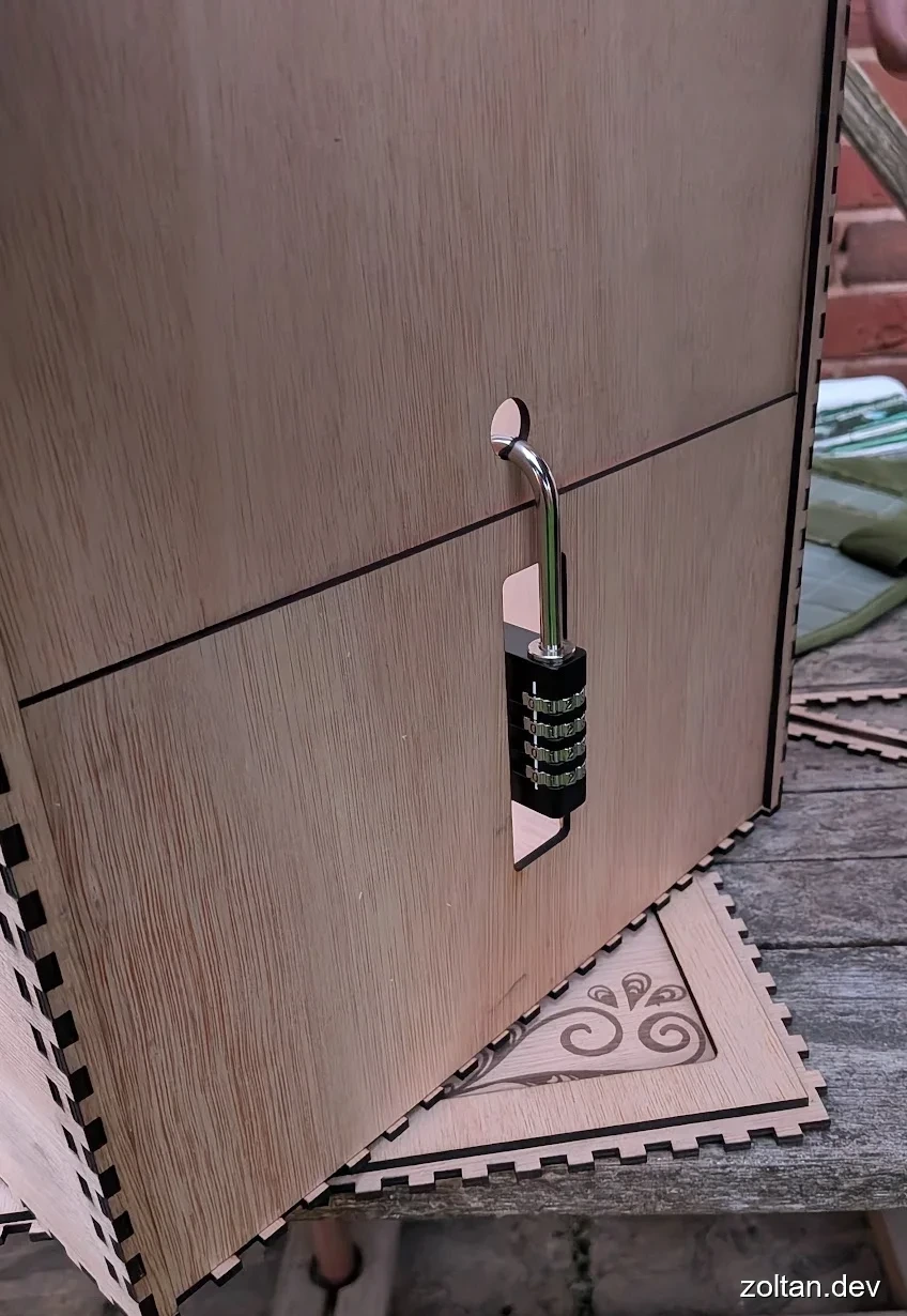Close-up of a wooden box with interlocking panels and a combination lock attached to it.